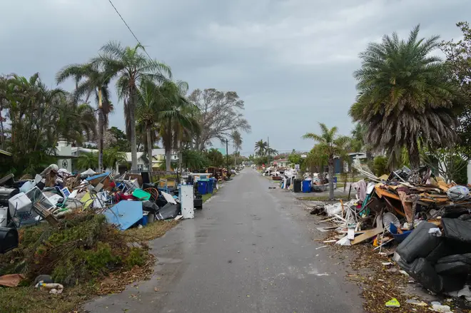 Debris from Hurricane Helene lines a street in the Redington Beach section of St. Petersburg, Florida